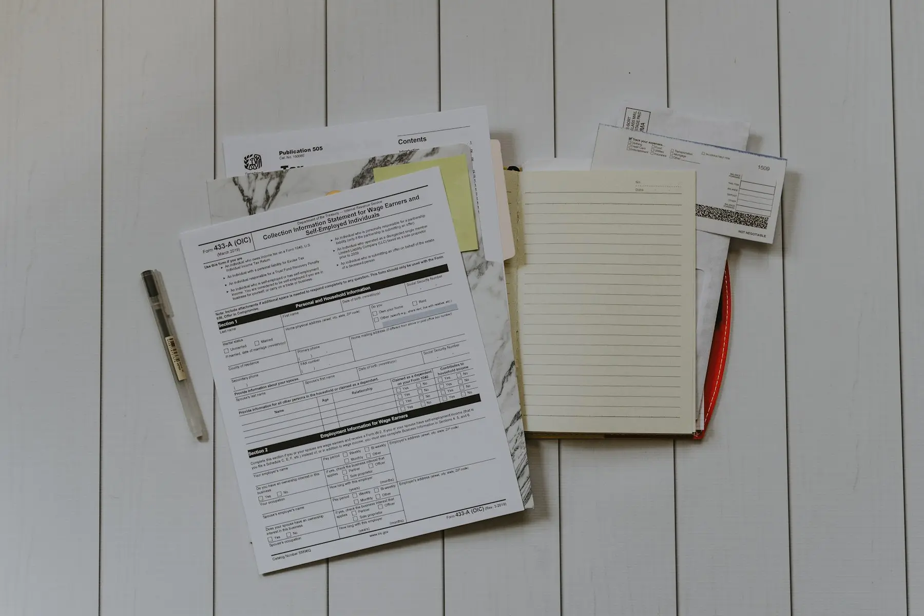 A stack of paper forms on a desk
